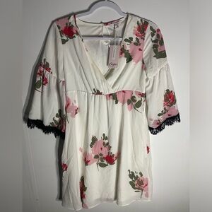 Candie’s floral babydoll blouse with black lace trim on sleeves.